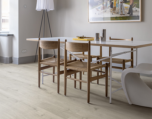 dining room with light grey vinyl floor and wooden chairs